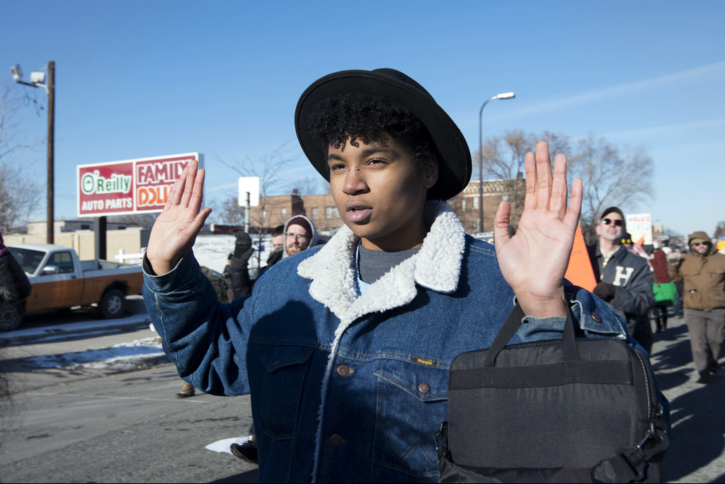 Person raising hands during street protest