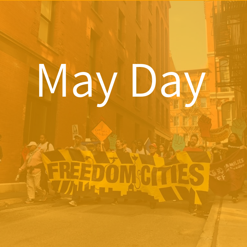 Protesters marching with FREEDOM CITIES banner